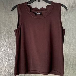 Dark brown sleeveless sweater with scalloped scoop neck.